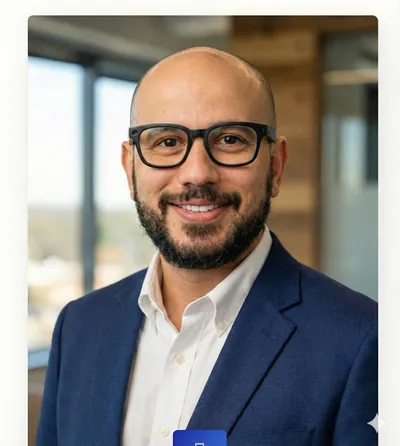 Mo Shalabi, founder of Project SAGE, wearing glasses and a navy blazer